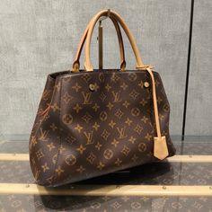 Brand: Louis Vuitton Condition: Excellent Condition Details: Minimal signs of wear, excellent overall condition. Exterior Material: Canvas Interior Material: Unknown Lining Material: Unknown Exterior Color: Brown Interior Color: Unknown Lining Color: Unknown Style: Satchel/Top Handle Bag Product Line: Louis Vuitton Montaigne Size: Large Handle/Strap Material: Leather Handle/Strap Color: Beige Hardware Color: Gold Character: LV Monogram Pattern: Monogram Dimensions: 13.78"W x 8.66"H x 5.91"D Handle Drop: 4" Strap Drop: 18" Accessories: Clochette, Detachable Strap Product Code: 606240806089 Department: Women Indulge in luxury with this Louis Vuitton Montaigne Satchel. Its spacious size and the signature LV monogram make it a timeless choice for your collection. The detachable strap adds vers Louis Vuitton Montaigne, Gold Character, Brown Interior, Monogram Pattern, Lv Monogram, Interior Color, Fendi Bags, Handle Bag, Canvas Tote Bag