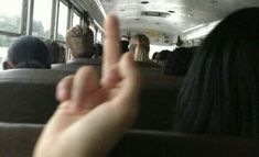 a person making the middle finger sign on a bus