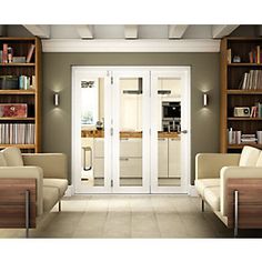 a living room filled with furniture and bookshelves