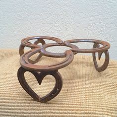 three metal heart shaped objects sitting on top of a table