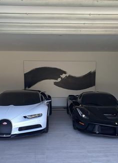 two bugatti cars parked in a garage next to each other on the floor