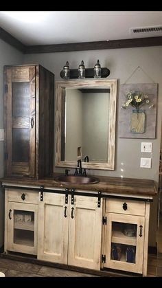 a bathroom with a sink, mirror and cabinets in it's own area is shown