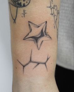 a person with a tattoo on their arm that has an image of a star in the middle