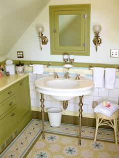 a white sink sitting under a bathroom mirror next to a green cabinet and counter top