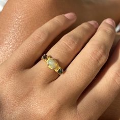 Choose between these gorgeous polished Ethiopian opal rings with amazing sparkles set in sterling silver and then gold plated. The ring has a little different faceted tourmaline on each side of the main stone. Choose between: Blue and yellow- N 1/2 (UK/AU size ring) 6 3/4 (US size) Green and brown- L 1/2 (UK/AU size ring) 5 7/8 (US size) Blue and pink- N 1/2 (UK/AU size ring) 6 3/4 (US size) Pink and brown- M 1/2 (UK/AU size ring) 6 1/4 (US size) This ring would make the most perfect bridesmaid' Yellow Gold Opal Ring With Gemstone Accents, Fine Jewelry Opal And Moonstone Multi-stone Ring, Opal And Moonstone Multi-stone Fine Jewelry Ring, Yellow Gold Moonstone Ring With Ethiopian Opal, Fine Jewelry Gold Opal Birthstone Ring, Gold Opal Gemstone Promise Ring, Gold Opal Promise Ring With Gemstone, Gold Opal Ring With Birthstone, Gold Opal Birthstone Ring