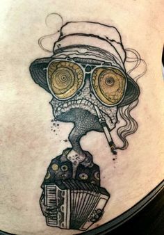 a woman's stomach with an image of a skull wearing glasses and a hat