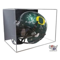 a green and yellow football helmet in a clear display case with writing on the side