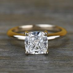 an engagement ring with a cushion cut diamond