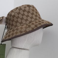 Product Description Gucci Reversible Bucket Hat Wool In A Close Weave Flat Crown Dropped Brim Front Logo Patch All-Over Check Motif All-Over Logo-Jacquard Motif At Reverse Made In Italy Brown Leather Trim Double G Made In Italy Gucci Brown Short Brim Hat, Gucci Adjustable Bucket Hat, Designer Brown Hat With Short Brim, Gucci Adjustable Brimmed Hat, Luxury Beige Visor Hat, Gucci Adjustable Short Brim Hat, Gucci Hat With Adjustable Size And Short Brim, Designer Adjustable Bucket Hat With Curved Brim, Designer Brown Brimmed Hat