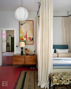 a bedroom with a canopy bed and white curtains