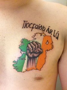 a man with a tattoo on his chest that has the irish flag and a fist