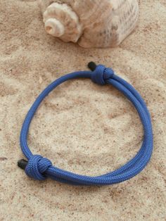 Paracord bracelet in navy blue. Perfect as a groomsmen gift or gift for sea and sailing inspired seaside wedding. Best friendship gift for man and woman. Nautical rope knot adjustable bracelet inspired by sailing in the sea will remind you a fabulous summer memories. Sliding cord wristband is adjustable so it will fit for all wrist sizes. *Navy blue and red bracelet with black ends *Beautiful neat finishing on the knot ends *Unisex, single wrap bracelet *Soft, flexible and strong *One size fits Adjustable Blue Nautical Bracelets, Adjustable Blue Bracelets For Outdoor, Adjustable Blue Nautical Bracelet, Adjustable Blue Braided Bracelets For Outdoor, Navy Nautical Adjustable Bracelets, Adjustable Navy Nautical Bracelet, Navy Adjustable Nautical Bracelet, Weding Gift, Navy Blue Groomsmen