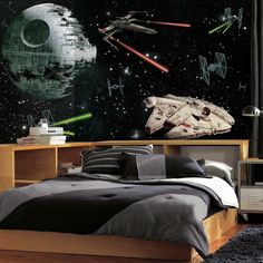 a bedroom with star wars wallpaper and bedding