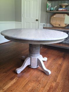 a white table sitting on top of a hard wood floor