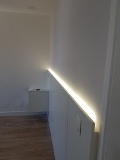 an empty room with some lights on the wall