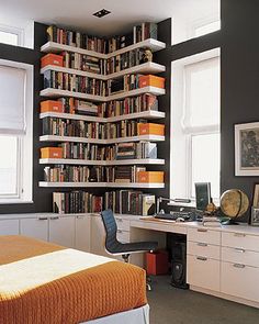 a bedroom with a bed, desk and bookshelf in it's corner