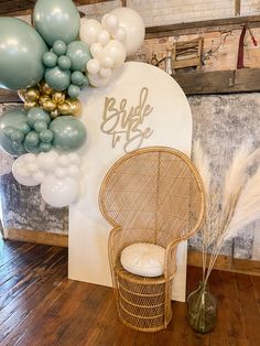 a chair and balloons are on display in a room