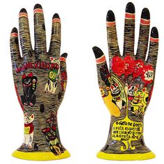 two hand sculptures made to look like they are wearing gloves with different designs on them