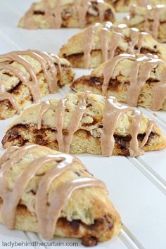 several scones with chocolate drizzled on them