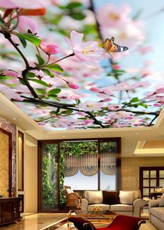 a living room filled with furniture and a ceiling painted with flowers on it's ceiling