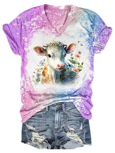 a women's pink shirt with a cow and flowers on it