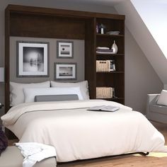 a bed with white sheets and pillows in a room next to a book shelf filled with books