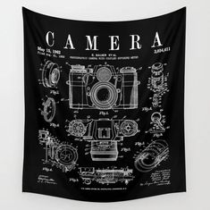 a black and white wall hanging with an image of a camera