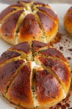 three hot cross buns with cheese and herbs on top