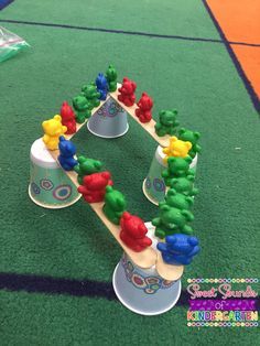 a cake shaped like a train on top of a green carpeted area with blue and yellow trim