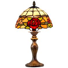 a table lamp with a rose design on the base and a stained glass shade over it