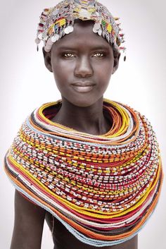 an african woman wearing a multicolored shawl