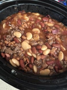 a crock pot filled with beans and meat