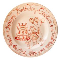 a birthday plate with an image of two people holding balloons and a cake on it