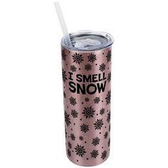 a pink tumbler with black snowflakes and the words i smell snow on it