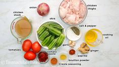 ingredients to make chicken broth laid out on a marble counter top, including tomatoes, onions, green beans, garlic, and seasoning