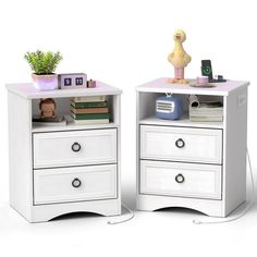 two white nightstands with books and toys on top of each one in front of a white background