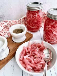 pickled red onions in mason jars with spoons