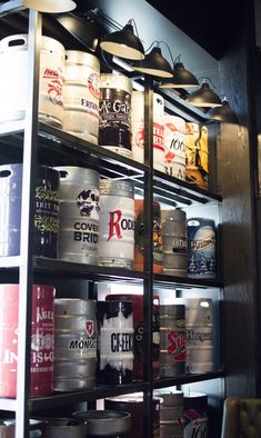 the shelves are filled with many different types of cans and buckets, all stacked on top of each other