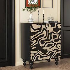 a black and white cabinet with an animal print design on the front, in a living room