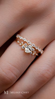 a woman's hand with three diamond rings on top of her finger and the bottom half