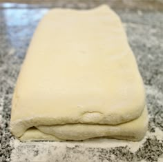 a long piece of dough sitting on top of a counter