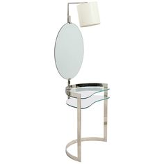 a glass table with a mirror on it and a lamp in the corner next to it