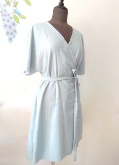 "Easy kimono sleeve summer wrap dress. Above knee or knee length. Versatile piece. Great for office wear or to a wedding. Made to order in sizes: S, M, L, XL Size S to fit bust 32-34\", waist 25-27\" and hips 35-37\" Size M to fit bust 36-38\", waist 29-31\" and hips 38-41\" Size L to fit bust 40-42\", waist 33-35\" and hips 42-44\" Size XL to fit bust 44-46\", waist 37-39\" and hips 45-47\" Available in Cotton or Linen. Blue dress on Mannequin is sold out" Fitted Summer Wrap Dress With Kimono Sleeves, Fitted Wrap Dress With Kimono Sleeves For Summer, Summer Belted A-line Wrap Dress, Belted Fitted Wrap Dress For Beach, Summer A-line Belted Wrap Dress, Summer Wrap Dress With Kimono Sleeves And Belted Waist, Summer Wrap Dress With Kimono Sleeves And Belt, Fitted Belted Dress With Kimono Sleeves, Belted Fitted Dress With Kimono Sleeves