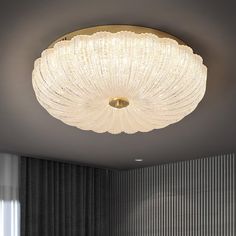 a large white chandelier hanging from the ceiling above a bed in a room