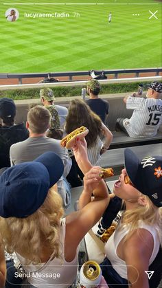 some people are eating pizza at a baseball game