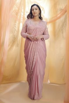 Rose gold saree highlighted with jaal embroidery. Comes with round neckline blouse.
Component: 2
Embroidered
Neckline: Round
Sleeve Length: Full
Fabric: Crepe, Silk
Color: Pink
Embroidered blouse - Aza Fashions Rose Gold Saree, Pastel Sarees, Saree With Heavy Blouse, Peacock Couture, Round Neckline Blouse, Baby Pink Saree, Rose Gold Fabric, Heavy Blouse, Pink Peacock