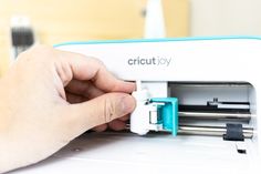 a person is using a cricut toy machine