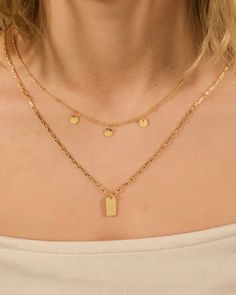 Luxe layers make this necklace one that you'll want to wear everywhere! One layer features dainty disk charms while the other features a smooth tag charm. Available in gold and silver tones. Material: 14K gold ﻿or﻿ rhodium plated brass Features: Measures 18-24" with 2" extender, 5mm disk, 0.75" tag, Lead & Nickel free, lobster clasp Disk Necklace, Layered Necklaces Silver, Disc Necklace, Layered Necklace, Gold And Silver, Layered Necklaces, Silver Necklaces, Rhodium Plated, Lobster Clasp