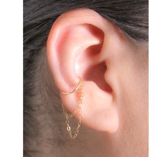 "This Simple and eye-catching Hoop Earring with Double Chain is very comfy, perfect for everyday wear and can be worn alone or combined with other earrings and cuffs. * Your choice of materials is: Sterling Silver, Rose Gold Filled or Gold Filled. Please choose from the drop-down menu. * Measurements: Conch Hoop inner diameter 10, 11 or 12 mm. Wire Thickness 20 Gauge. * Materials: 14K Gold Filled or .925 Sterling Silver cuff and chain. * Nickel and Lead Free (Hypoallergenic) perfect for sensitive skin. * 100% top quality USA materials.  * Your new jewelry ships nicely wrapped in a jewelry box, ready for gift giving. * No piercing? No problem!! I also have a listing in a \"Cuff\" version:   https://www.etsy.com/listing/827558987/conch-ear-cuff-earring-with-dangling * If you like what you se Earring Cuff Chain, Conch Hoop, Cuff Earring, Conch Earring, Piercing Ideas, Ear Cuff Earings, Conch Piercing, Minimal Jewelry, Ear Piercing