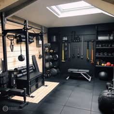 a home gym with black walls and flooring